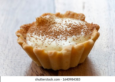 A close up view of a small homemade milk tart on a isolated background  - Shutterstock ID 1640984383