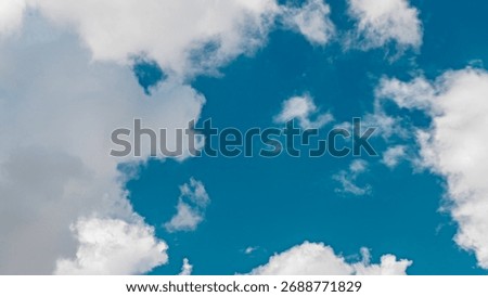 Close up view of some cumulus clouds during stormy weather timelapse. Massive cumulus cloud in the summer sky before rain. Blue sky background with white clouds