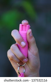 Close up view of someone holding Pink Pepper Spray