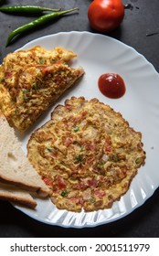 Close Up View Of Spicy Masala Omelette On Plate With Condiments.