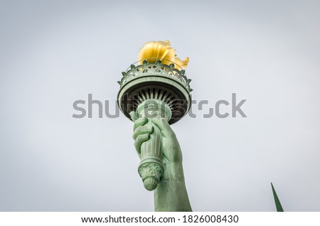 Close Up View of Statue of Liberty Torch Enlightening the World with a Golden Flame in Manhattan, New York City, USA