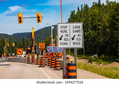 A Close Up View Of A Stop Here On Red Signal Sign In French And English, Major Roadworks And Infrastructure Improvements In Canada, With Copy Space