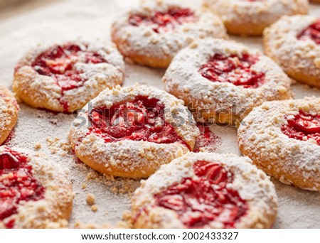 Close up view of strawberry crumble sweet  buns  sprinkled with powdered sugar, focus on the bun inside. Traditional sweet pastries called kolaches