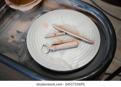   Close up view of string cutter and pottery tools . pottery, workshop, ceramics art concept . High angle view  - Powered by Shutterstock