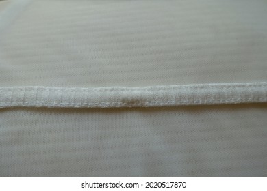 Close View Of Stripe Of White Fabric Seamed To Mesh