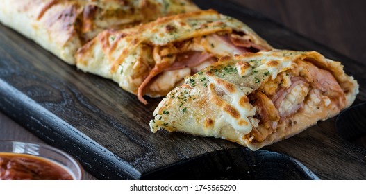 A Close Up View Of Stromboli Fresh Out Of The Oven And Sliced Ready For Eating.