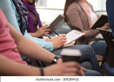 Close up view of student taking notes during lecture - Shutterstock ID 309289910