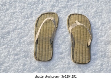 Close View Of Summer Flip Flop Sandals On The White Snow