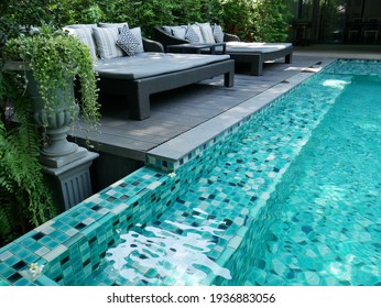 close up view of swimming pool and outdoor daybeds