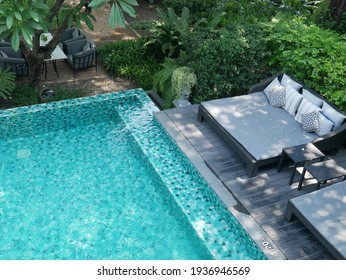 close up view of swimming pool and outdoor daybeds