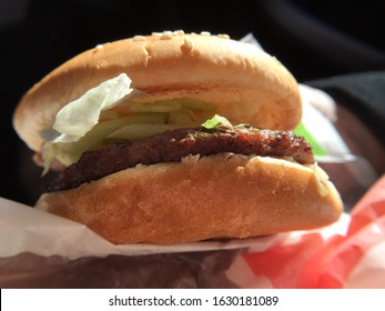 Close Up View Of A Tasty Beef Burger Topped With Shredded Lettuce