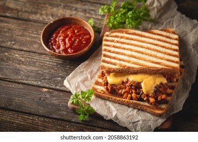 Close Up View Of Tasty Sloppy Joe Sandwich With Ground Meat, Sauce And Cheese On Wooden Background