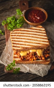 Close Up View Of Tasty Sloppy Joe Sandwich With Ground Meat, Sauce And Cheese On Wooden Background