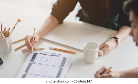 Close up view of team application developer concentrating on UI project  in modern meeting room 