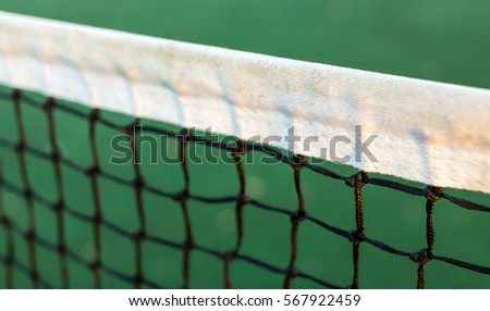 Close up view of tennis court through the net