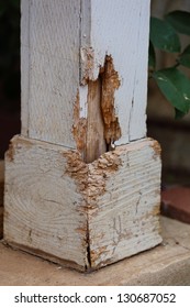 Close up view of termite damage on a outside pillar of a house