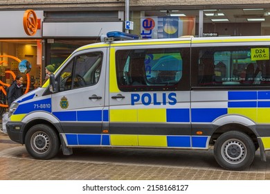 Close up view of tourist pedestrian area with shops and police car in downtown. Sweden. Uppsala. 05.14.2022.