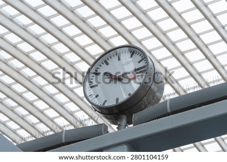 Close view of a train station round clock at Liège-Guillemins station