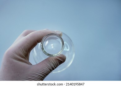 Close up view of transparent glass flask for biological research. Isolated on background. Laboratory tests and research. Chemistry science or medical biology experiment. Laboratory background - Shutterstock ID 2140195847