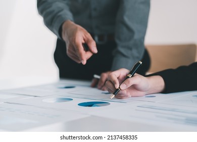 Close up view of two businessman consulting on their project with digital tablet and document file on white table