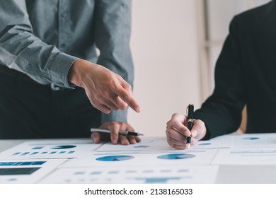 Close up view of two businessman consulting on their project with digital tablet and document file on white table