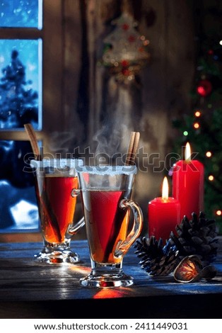 close up view of two glasses with mulled wine on color back