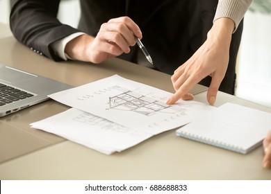 Close up view of two-story house construction project, architects discuss home building architectural plan, agents determine price of real estate object for sale, property value estimation appraisal - Powered by Shutterstock