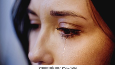 Close Up View Of Upset Woman Crying With Tears On Face On Grey Background