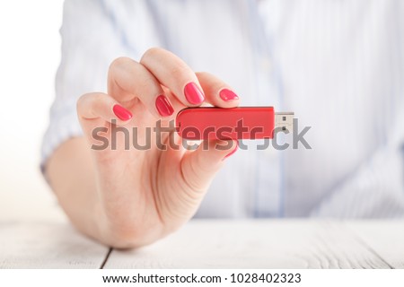 Close up view of usb flash pendrive in female hand