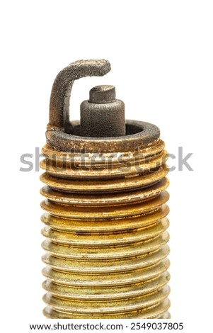 close up view of used spark plug. showing it's tip and electrode wear.