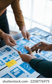 Close up view of ux developer and ui designer brainstorming about mobile app interface wireframe design.