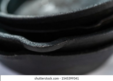 Close up view. Variety of cast iron frying pans on a marble background.