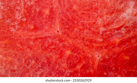 Close up view of vibrant red watermelon pulp texture, showcasing its intricate details, natural patterns, and fresh organic feel. Macro shot - Powered by Shutterstock