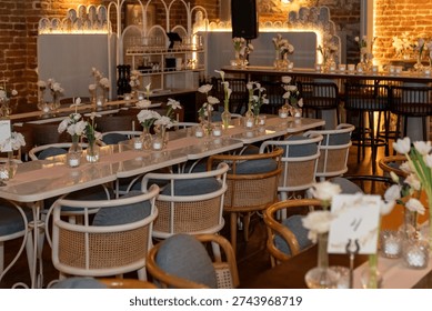 Close up view of wedding table setting with flowers and candles in a warm scene.