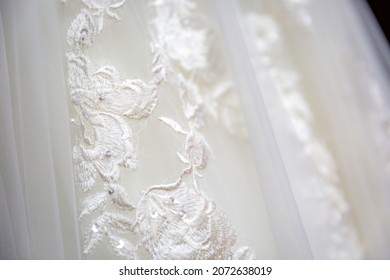 Close Up View White Flowers Pattern On White Wedding Dress. Classic Wedding Dress Styles Concept