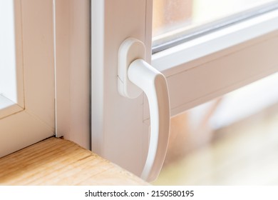 Close Up View For White Pvc Balcony Door Handle. Closed Patio Door. Window Repair Concept.