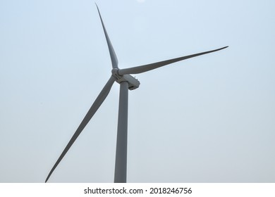 Close Up View If The A Wind Turbine With A Clear Sky Background