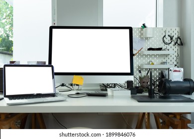 Close up view of workplace with computer, camera on white table.
