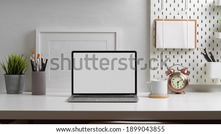 Close up view of worktable with laptop, stationery and decorations in home office room, clipping path