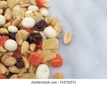 Close View Of Yogurt Covered Raisin, Fruit And Nut Trail Mix On A Gray Marble Counter Top.