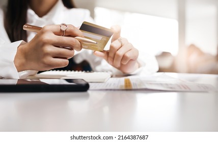 Close Up  View, Young Asian Girl Holdind Credit Card To Paying Online For An Order Via Mobile App And Checking Order In Bank Statement, Online Shopping, Paying Online Via Mobile App