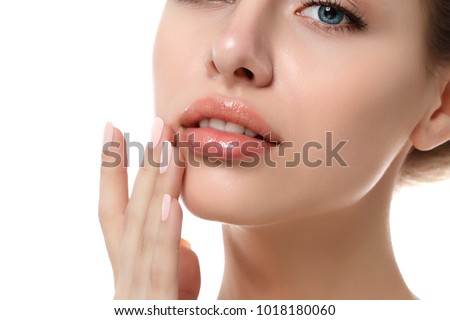 Close up view of young beautiful caucasian woman face isolated over white background. Lips contouring, SPA therapy, skincare, cosmetology and plastic surgery concept