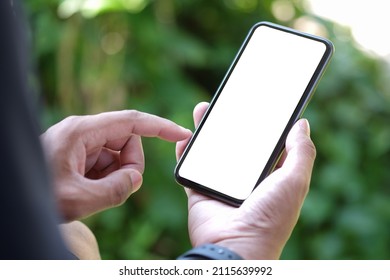 Close up view young man sitting in the park and using smart phone. - Powered by Shutterstock