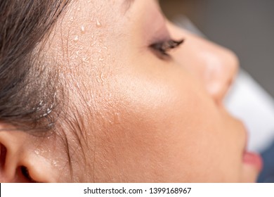 Close Up View Of Young Woman With Sweaty Face Suffering From Heat On Grey 