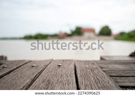 close up vintage old wood plate at pier with river background.