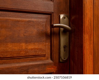 Close up of a vintage style house door handle with gold color and bright red brown door. - Powered by Shutterstock