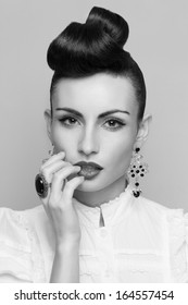 Close Up Of Vintage Styling Model With Makeup And Updo. Accessories. Red Lips. White Lacy Shirt