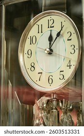Close up Vintage table clock without alarm on a table. View through the window Antique Clock, retro style. The old clock. Nobody, selective focus