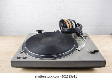 Close Up Vintage Turn Table With Headphone On Wooden Floor For Template Music