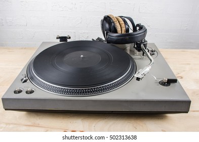 Close Up Vintage Turn Table With Headphone On Wooden Floor For Template Music